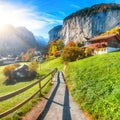 Gorgeous autumn landscape of  alpine village Lauterbrunnen with famous church and Staubbach waterfall Royalty Free Stock Photo