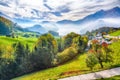 Gorgeous autumn view on suburb of Stansstad city and Lucerne lake with mountaines and fog Royalty Free Stock Photo