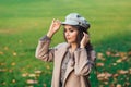 Gorgeous beautiful fashion woman in autumn park. Fashion portrait of beautiful girl with luxury makeup, long curly hair in stylish