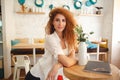 Gorgeous beautiful redhead young lady posing in cafe Royalty Free Stock Photo