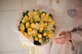 Gorgeous bouquet of yellow tulips in girl`s hands Royalty Free Stock Photo