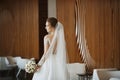 Gorgeous beauty portrait of a young bride. Beautiful bride with wedding hairstyle and makeup in a trendy dress with the Royalty Free Stock Photo