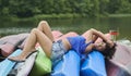 Prety biracial woman poses on canoes