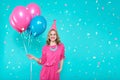 Gorgeous birthday girl in party outfit holding colourful balloons. Attractive trendy teenager celebrating birthday. Party.