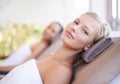 Its here that I let my worries wash away. A gorgeous blond woman looking at you while lying on a spa bed. Royalty Free Stock Photo