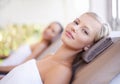 Its here that I let my worries wash away. A gorgeous blond woman looking at you while lying on a spa bed. Royalty Free Stock Photo