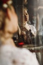 Gorgeous blonde bride posing near mirror, reflection of wom Royalty Free Stock Photo