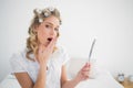 Gorgeous blonde wearing hair curlers yawning Royalty Free Stock Photo