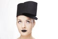 Gorgeous blonde woman model with blue eyes and black lipstick wearing big stylish designer black unique hat/ headpiece