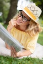 gorgeous blonde woman reading magazine in park Royalty Free Stock Photo