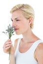 Gorgeous blonde woman smelling flowers Royalty Free Stock Photo