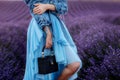 Gorgeous blue dress on a girl on the background of a lavender field