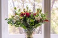 gorgeous bouquet of the various flowers standing next to the window decorating the home interior design