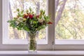 gorgeous bouquet of the various flowers standing next to the window decorating the home interior design