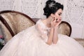 Gorgeous bride with dark hair in luxuious wedding dress