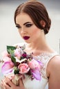 Gorgeous bride with fashion makeup and hairstyle in a luxury wedding dress Royalty Free Stock Photo