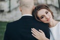 Gorgeous bride and groom embracing in evening sunlight near old castle in park. Romantic moment. Stylish wedding couple gently Royalty Free Stock Photo