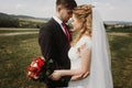 Gorgeous bride and groom posing at field. luxury wedding couple Royalty Free Stock Photo