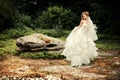 Gorgeous bride in a lush white dress is dancing.