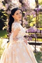 Gorgeous bride in luxurious wedding dress, posing in blossom garden Royalty Free Stock Photo