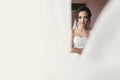 Gorgeous bride portrait with amazing look. beautiful woman getting ready for wedding, sexy model posing near window in morning Royalty Free Stock Photo