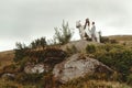 Gorgeous bride riding a white horse and stylish groom, boho wed