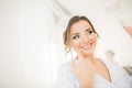 Gorgeous bride in robe posing and preparing for the wedding ceremony face in a room Royalty Free Stock Photo