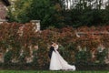 Gorgeous bride and stylish groom gently hugging and smiling at Royalty Free Stock Photo