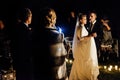 Gorgeous bride and stylish groom having their first dance at romantic candle light at evening wedding ceremony Royalty Free Stock Photo