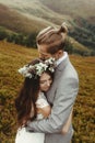 Gorgeous bride and stylish groom hugging at sunny landscape, bo Royalty Free Stock Photo