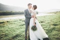 Gorgeous bride and stylish groom walking at sunny landscape, wedding couple, luxury ceremony mountains with amazing view Royalty Free Stock Photo