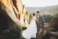 Gorgeous bride and stylish groom walking at sunny landscape, wedding couple, luxury ceremony mountains with amazing view Royalty Free Stock Photo