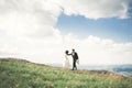 Gorgeous bride and stylish groom walking at sunny landscape, wedding couple, luxury ceremony mountains with amazing view Royalty Free Stock Photo