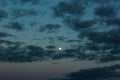 Gorgeous bright moon and few clouds on dark blue night sky. Amazing nature background