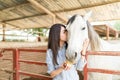 Woman Kissing Horse During Equine Therapy