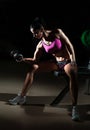 Gorgeous brunette lifting some weights and working on her biceps in a gym. Fitness woman doing workout. Sporty girl doing exercise Royalty Free Stock Photo