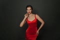 Gorgeous brunette model woman in red dress posing in studio Royalty Free Stock Photo