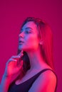 Closeup face of beautiful brunete woman in neon light red and blue