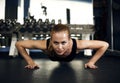 Gorgeous brunette warming up and doing some push ups at gym Royalty Free Stock Photo