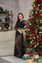 Gorgeous brunette women in a black evening dress celebrating New Year and Christmas Royalty Free Stock Photo