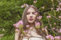 Gorgeous brunette woman portrait. Beautiful female model with long hair and make-up in spring garden outdoor Royalty Free Stock Photo