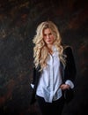 Gorgeous business lady in black suit and white shirt on black background, portrait of beautiful woman Royalty Free Stock Photo