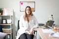 Pretty dietician sitting at her office