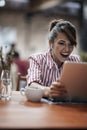 Gorgeous caucasian female, smiling, delighted with content on laptop