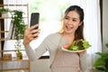 Gorgeous Asian female or housewife take a picture of herself and her homemade salad Royalty Free Stock Photo