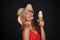 Attractive cheerful Caucasian woman in straw summer hat red swimsuit with white polka dots, holding delicious ice cream cone , Royalty Free Stock Photo