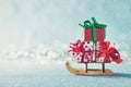 Gorgeous christmas presents on Santas sleigh. Miniature Christmas winter wonderland. Xmas greeting card. Royalty Free Stock Photo