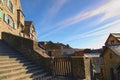 Gorgeous cityscape of medieval Mont Saint-Michel village. Narrow streets with ancient stone houses. Blue sky background.