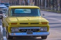 Gorgeous classic yellow 1965 GMC pickup truck parked outdoors on a sunny day. Royalty Free Stock Photo