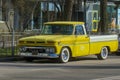 Gorgeous classic yellow 1965 GMC pickup truck parked outdoors on a sunny day. Royalty Free Stock Photo